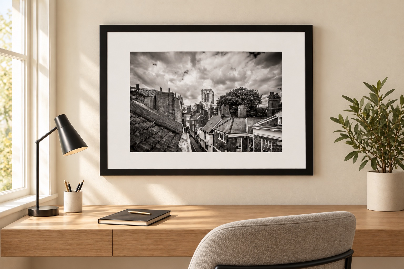 Framed black-and-white photograph of York rooftops and the Minster in a contemporary home office